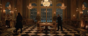 Movie still from “The King's Man” (2021), directed by Matthew Vaughn – A man standing in front of a dining room table; Extreme Wide shot, High angle
