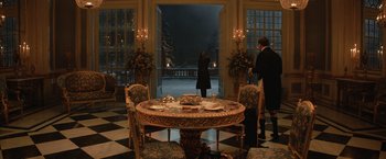 Movie still from “The King's Man” (2021), directed by Matthew Vaughn – A table and chairs set up for a formal dinner; Extreme Wide shot, Over the shoulder angle