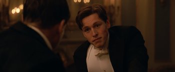 Movie still from “The King's Man” (2021), directed by Matthew Vaughn – A man in a tuxedo looking at a man in a suit; Close Up shot, Over the shoulder angle