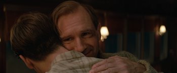 Movie still from “The King's Man” (2021), directed by Matthew Vaughn – A person hugging a person; Close Up shot, Over the shoulder angle