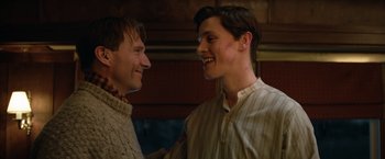 Movie still from “The King's Man” (2021), directed by Matthew Vaughn – Two men are smiling and talking to each other; Close Up shot, Over the shoulder angle