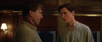 Movie still from “The King's Man” (2021), directed by Matthew Vaughn – Two men standing next to each other in front of a window; Close Up shot, Low angle