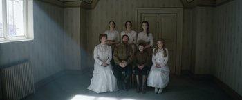 Movie still from “The King's Man” (2021), directed by Matthew Vaughn – A group of people dressed in old - fashioned clothing; Medium shot, Low angle