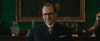 Movie still from “The King's Man” (2021), directed by Matthew Vaughn – A person wearing a suit and tie; Close Up shot, Low angle