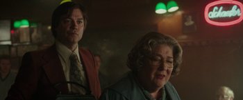 Movie still from “The Kitchen” (2019), directed by Andrea Berloff – A man and a woman sitting next to each other in a room; Medium shot, Over the shoulder angle