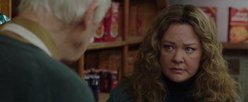 Movie still from “The Kitchen” (2019), directed by Andrea Berloff – A woman with long curly hair is looking at another woman; Close Up shot, Over the shoulder angle
