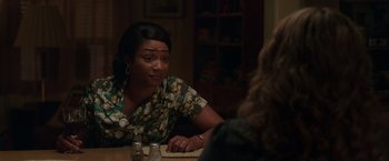 Movie still from “The Kitchen” (2019), directed by Andrea Berloff – A woman sitting at a table in front of another woman; Close Up shot, Over the shoulder angle