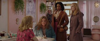 Movie still from “The Kitchen” (2019), directed by Andrea Berloff – A group of women standing around a table; Medium shot, Over the shoulder angle