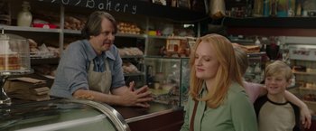 Movie still from “The Kitchen” (2019), directed by Andrea Berloff – A man and a woman at a bakery counter; Medium shot, Over the shoulder angle