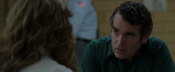 Movie still from “The Kitchen” (2019), directed by Andrea Berloff – A man and a woman sitting in front of each other in a room; Close Up shot, Over the shoulder angle