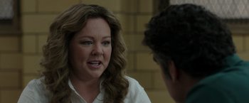 Movie still from “The Kitchen” (2019), directed by Andrea Berloff – A woman talking to a man in front of a brick wall; Close Up shot, Over the shoulder angle