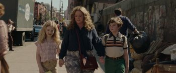 Movie still from “The Kitchen” (2019), directed by Andrea Berloff – A woman and two children walking down a street; Medium shot, Over the shoulder angle