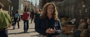 Movie still from “The Kitchen” (2019), directed by Andrea Berloff – A group of people walking down a street; Medium shot, Over the shoulder angle