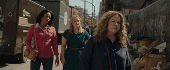 Movie still from “The Kitchen” (2019), directed by Andrea Berloff – A group of people walking down a street; Medium shot, Over the shoulder angle
