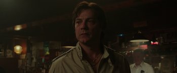 Movie still from “The Kitchen” (2019), directed by Andrea Berloff – A person wearing a jacket; Close Up shot, Low angle