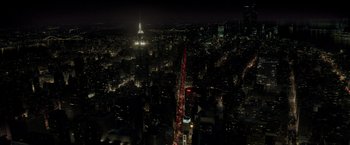 Movie still from “The Kitchen” (2019), directed by Andrea Berloff – An aerial view of a city at night with lights on; Extreme Wide shot, High angle