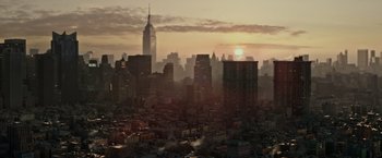 Movie still from “The Kitchen” (2019), directed by Andrea Berloff – The sun is setting over a large city; Extreme Wide shot, High angle