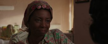 Movie still from “The Kitchen” (2019), directed by Andrea Berloff – A person wearing a head scarf; Close Up shot, Over the shoulder angle