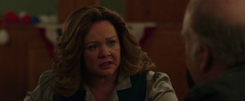 Movie still from “The Kitchen” (2019), directed by Andrea Berloff – An older woman with long brown hair is looking at the camera; Close Up shot, Over the shoulder angle