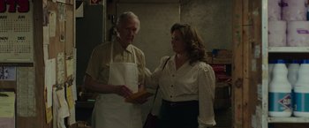Movie still from “The Kitchen” (2019), directed by Andrea Berloff – An older man and a younger woman in a kitchen; Medium shot, Over the shoulder angle