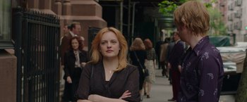 Movie still from “The Kitchen” (2019), directed by Andrea Berloff – A woman standing on a sidewalk with her arms crossed; Close Up shot, Over the shoulder angle