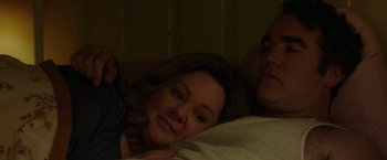Movie still from “The Kitchen” (2019), directed by Andrea Berloff – A woman and a man laying on a bed; Close Up shot, Overhead angle