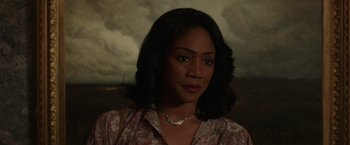 Movie still from “The Kitchen” (2019), directed by Andrea Berloff – A person wearing a floral shirt; Close Up shot, High angle