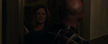 Movie still from “The Kitchen” (2019), directed by Andrea Berloff – A woman looking into a mirror in a dark room; Close Up shot, Over the shoulder angle