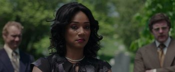 Movie still from “The Kitchen” (2019), directed by Andrea Berloff – A person wearing a dress; Close Up shot, Over the shoulder angle