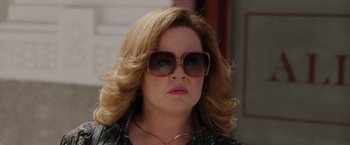 Movie still from “The Kitchen” (2019), directed by Andrea Berloff – A person wearing sunglasses; Close Up shot, Over the shoulder angle