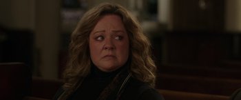 Movie still from “The Kitchen” (2019), directed by Andrea Berloff – A person with curly blonde hair; Close Up shot, Over the shoulder angle