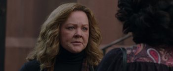 Movie still from “The Kitchen” (2019), directed by Andrea Berloff – An older woman is looking into the distance; Close Up shot, Over the shoulder angle