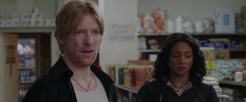 Movie still from “The Kitchen” (2019), directed by Andrea Berloff – A man and a woman standing next to each other in a store; Close Up shot, Over the shoulder angle
