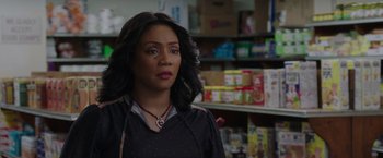 Movie still from “The Kitchen” (2019), directed by Andrea Berloff – A woman standing in front of a shelf in a store; Close Up shot, Over the shoulder angle