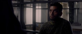 Movie still from “The Last Letter from Your Lover” (2021), directed by Augustine Frizzell – A person wearing a sweater; Close Up shot, Over the shoulder angle