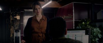 Movie still from “The Last Letter from Your Lover” (2021), directed by Augustine Frizzell – A woman standing next to a man in front of a computer screen; Medium shot, Over the shoulder angle