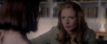 Movie still from “The Last Letter from Your Lover” (2021), directed by Augustine Frizzell – A woman sitting in front of another woman in front of a book shelf; Close Up shot, Over the shoulder angle