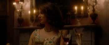 Movie still from “The Last Letter from Your Lover” (2021), directed by Augustine Frizzell – A beautiful woman in a floral print dress; Medium shot, Over the shoulder angle
