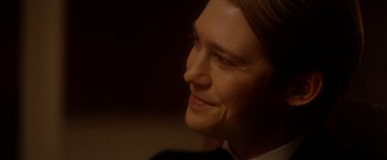 Movie still from “The Last Letter from Your Lover” (2021), directed by Augustine Frizzell – A person's face in a dark room; Close Up shot, Over the shoulder angle