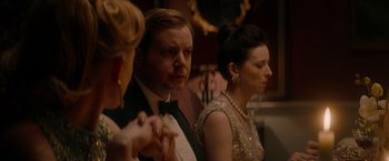 Movie still from “The Last Letter from Your Lover” (2021), directed by Augustine Frizzell – A man and two women in formal attire; Close Up shot, Over the shoulder angle