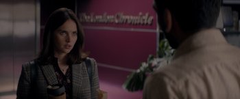 Movie still from “The Last Letter from Your Lover” (2021), directed by Augustine Frizzell – A woman standing in front of a man in front of a building; Close Up shot, Over the shoulder angle