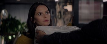 Movie still from “The Last Letter from Your Lover” (2021), directed by Augustine Frizzell – A woman holding onto a white blanket while looking at something; Close Up shot, Over the shoulder angle