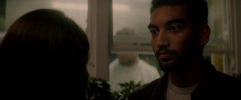 Movie still from “The Last Letter from Your Lover” (2021), directed by Augustine Frizzell – A man standing in front of a window looking at another man; Close Up shot, Over the shoulder angle