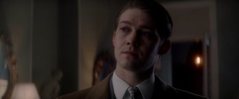 Movie still from “The Last Letter from Your Lover” (2021), directed by Augustine Frizzell – A man in a suit and tie looking to his left; Close Up shot, Over the shoulder angle