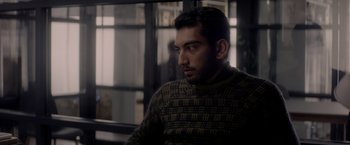 Movie still from “The Last Letter from Your Lover” (2021), directed by Augustine Frizzell – A person sitting in a room; Medium shot, Over the shoulder angle