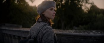 Movie still from “The Last Letter from Your Lover” (2021), directed by Augustine Frizzell – A woman wearing a hat and a jacket; Close Up shot, Over the shoulder angle