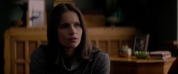 Movie still from “The Last Letter from Your Lover” (2021), directed by Augustine Frizzell – A person sitting in a room; Close Up shot, Over the shoulder angle