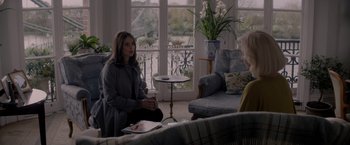 Movie still from “The Last Letter from Your Lover” (2021), directed by Augustine Frizzell – Two women are sitting in a living room talking; Medium shot, Over the shoulder angle