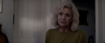 Movie still from “The Last Letter from Your Lover” (2021), directed by Augustine Frizzell – An older woman with white hair looking at the camera; Close Up shot, Over the shoulder angle
