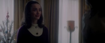 Movie still from “The Last Letter from Your Lover” (2021), directed by Augustine Frizzell – A woman standing in front of a window with a candle; Close Up shot, Over the shoulder angle